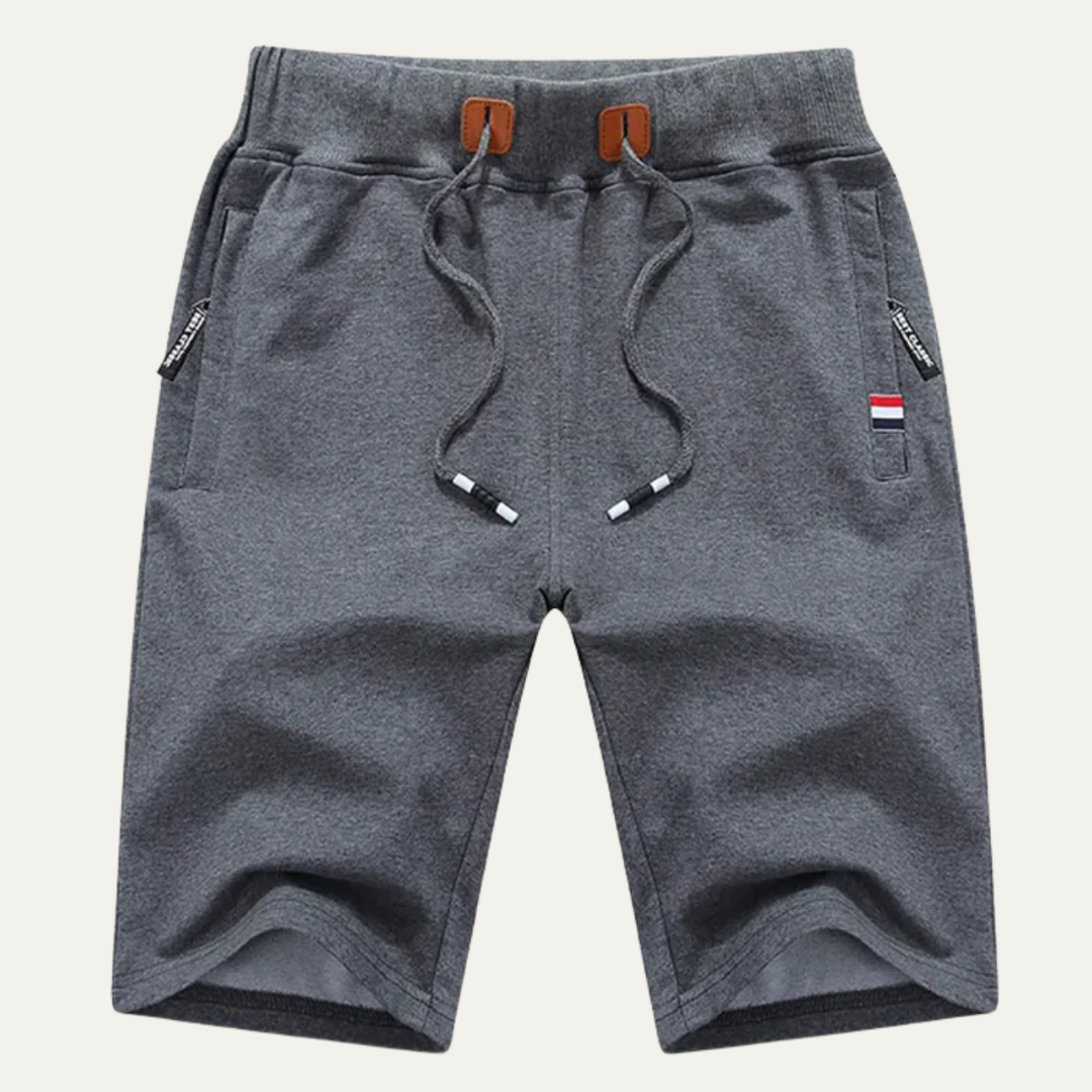 Dark gray men jogger shorts with drawstring, side pockets, and soft textured fabric