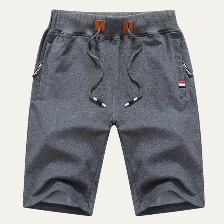 Dark gray men jogger shorts with drawstring, side pockets, and soft textured fabric
