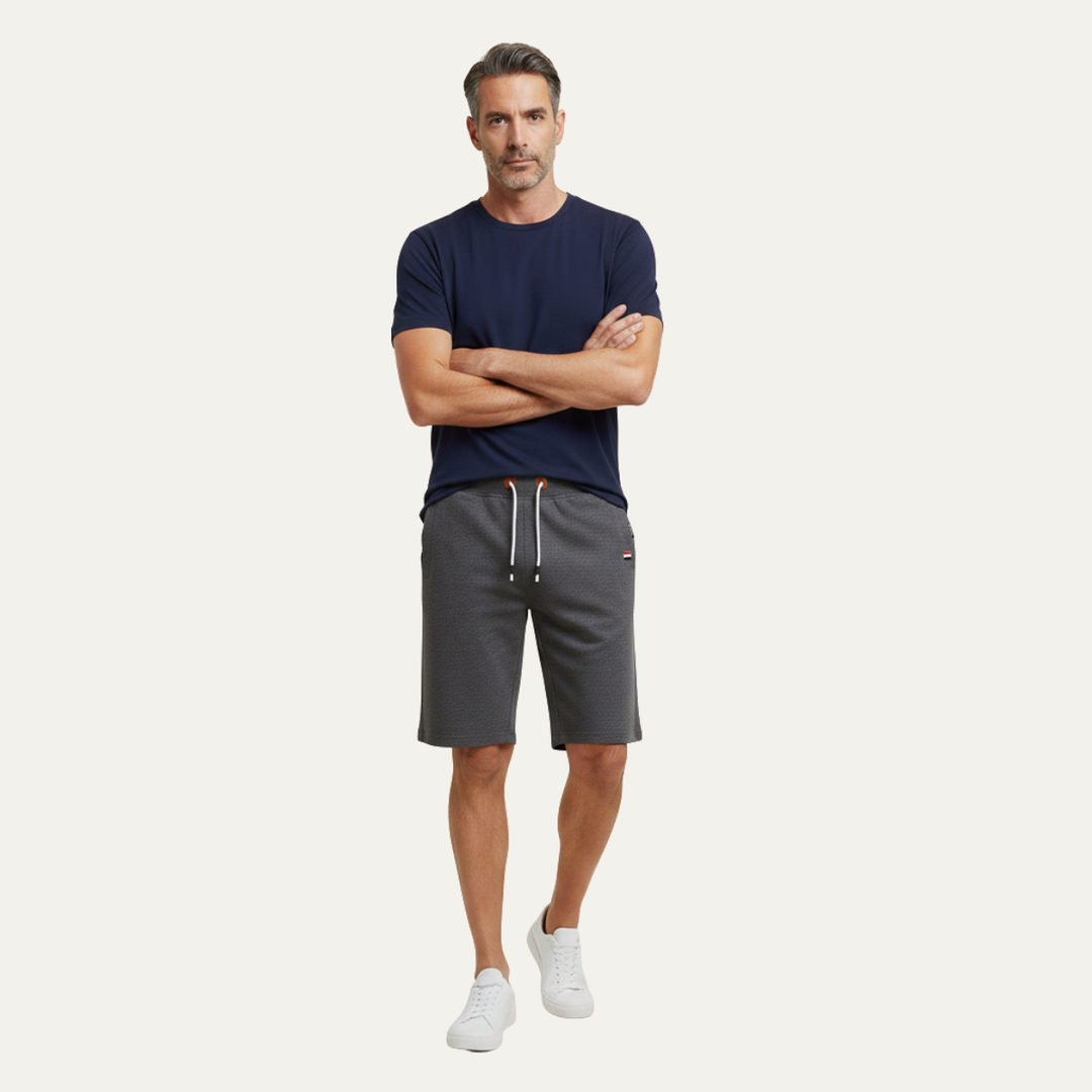 Model wearing dark gray casual jogger shorts with drawstring and knee-length cut