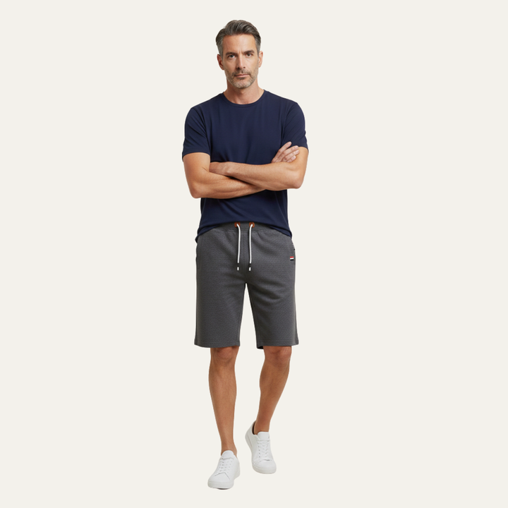 Model wearing dark gray casual jogger shorts with drawstring and knee-length cut