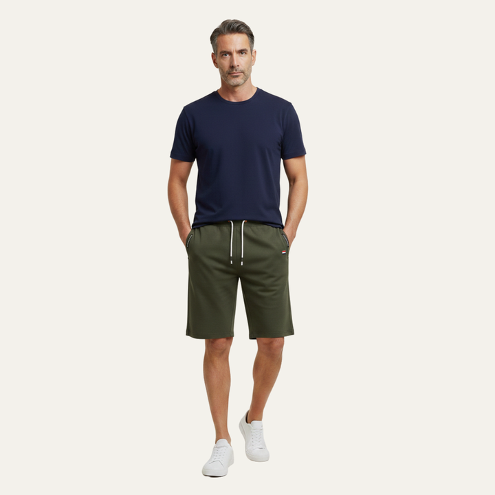 Model wearing olive green jogger shorts with drawstring and relaxed casual style