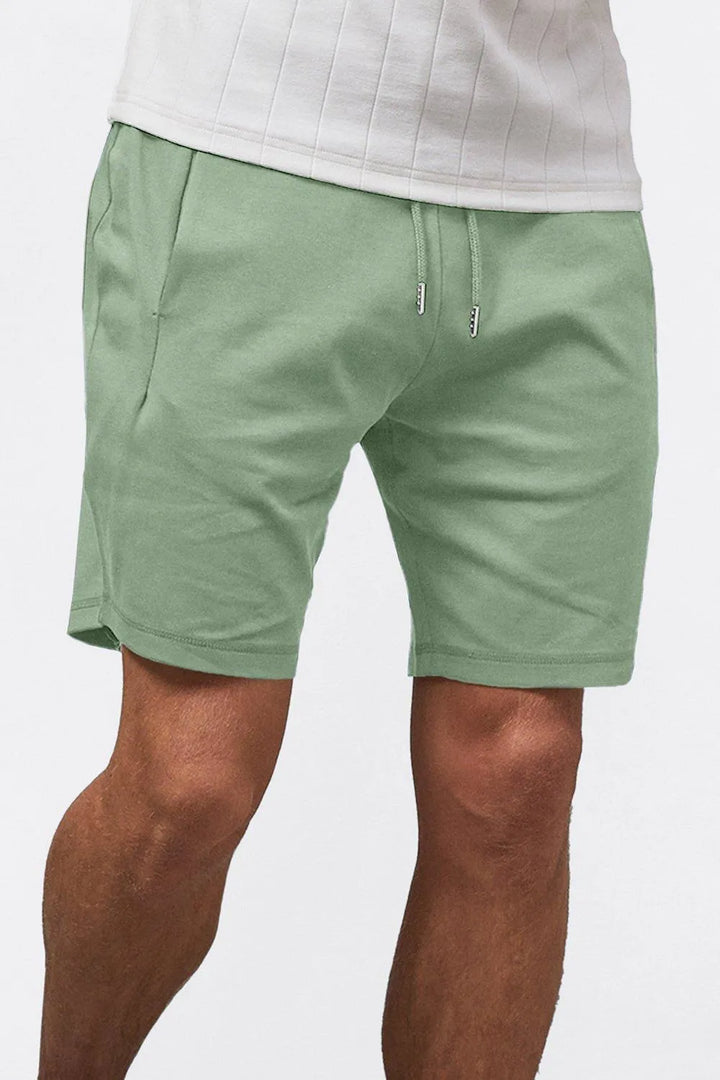 Mint green men casual summer drawstring shorts close-up with drawstring waist and clean hem