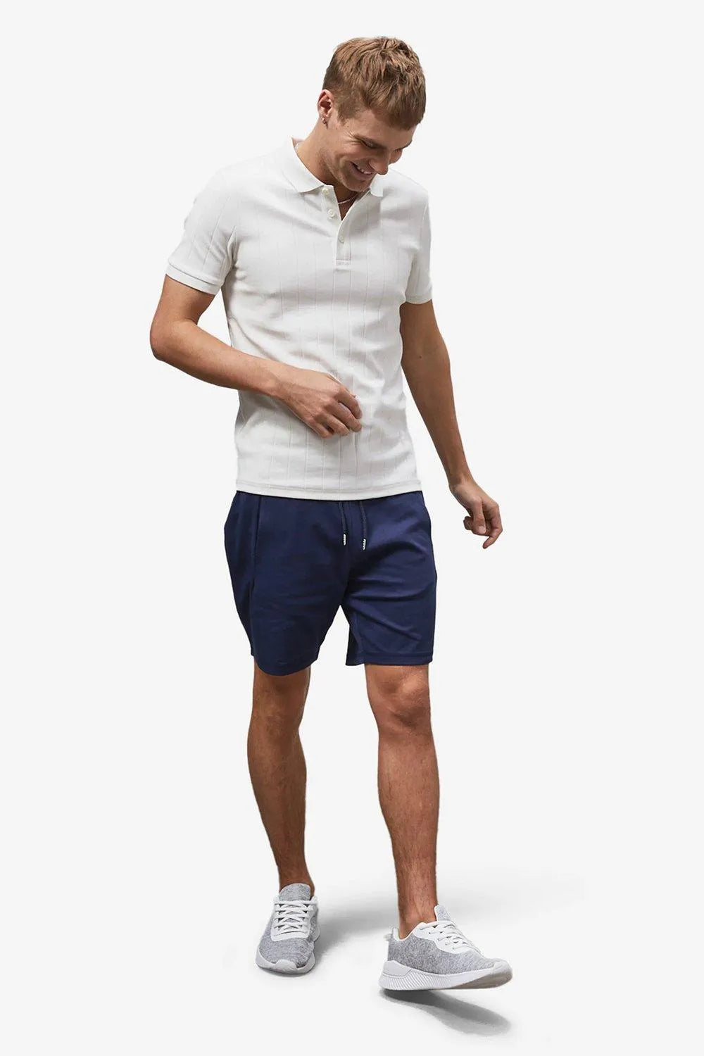 Men navy drawstring shorts styled with a white polo shirt and sneakers, casual summer shorts