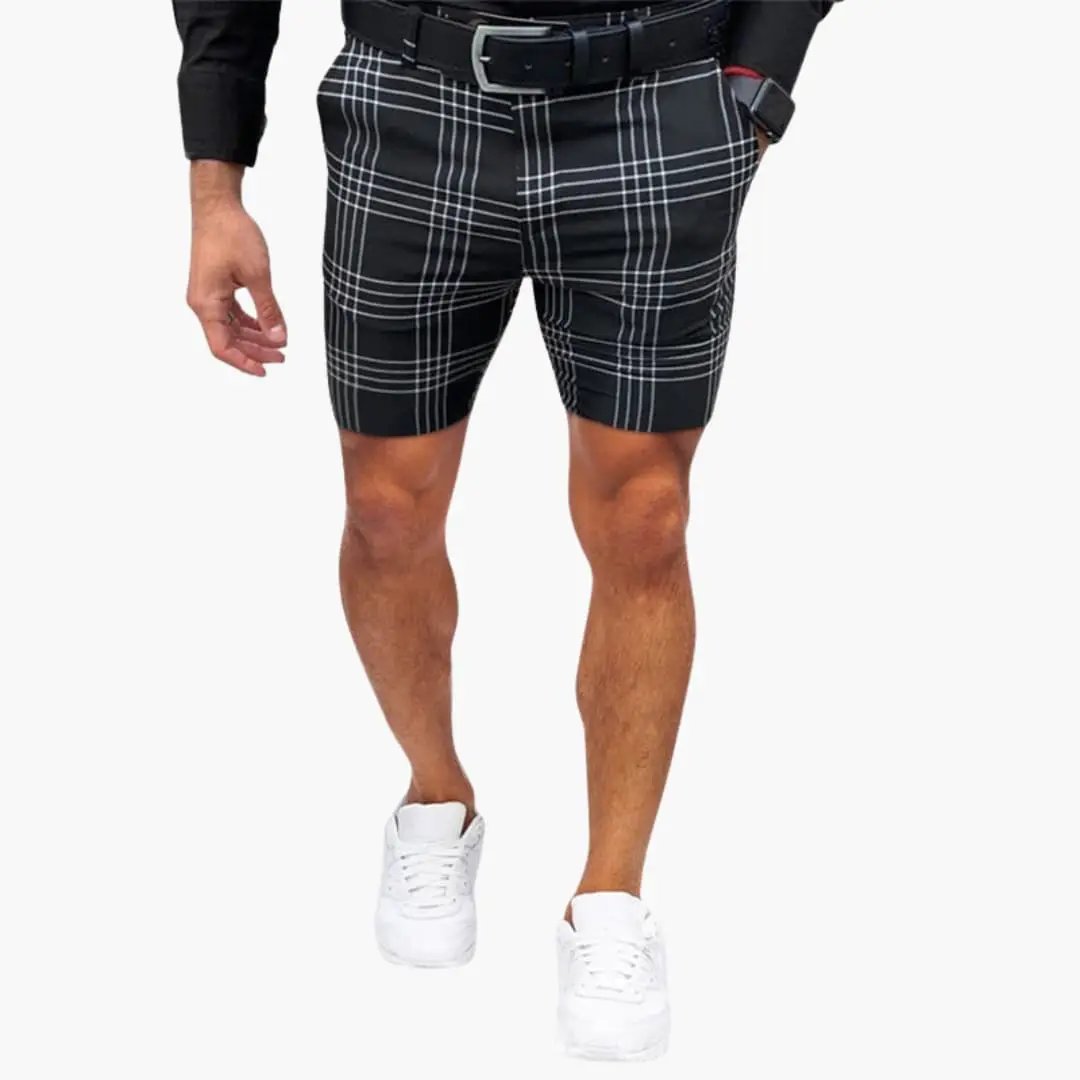 Black checkered above knee shorts with white grid pattern, belt loops and white sneakers