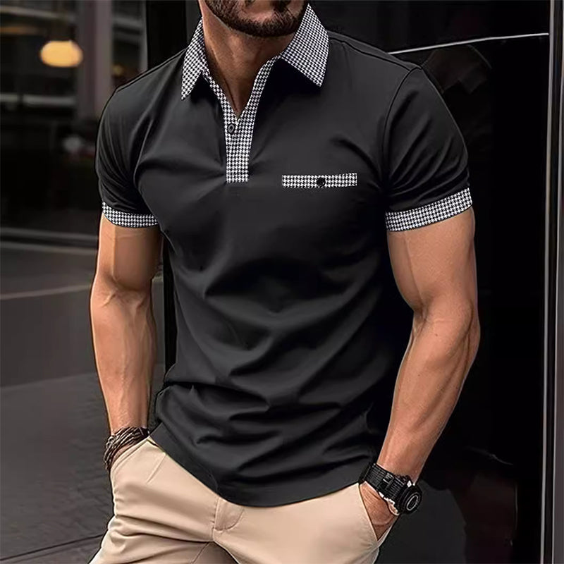 Black short sleeve polo shirt with checkered collar, pocket trim, and sleeve cuffs on a male model