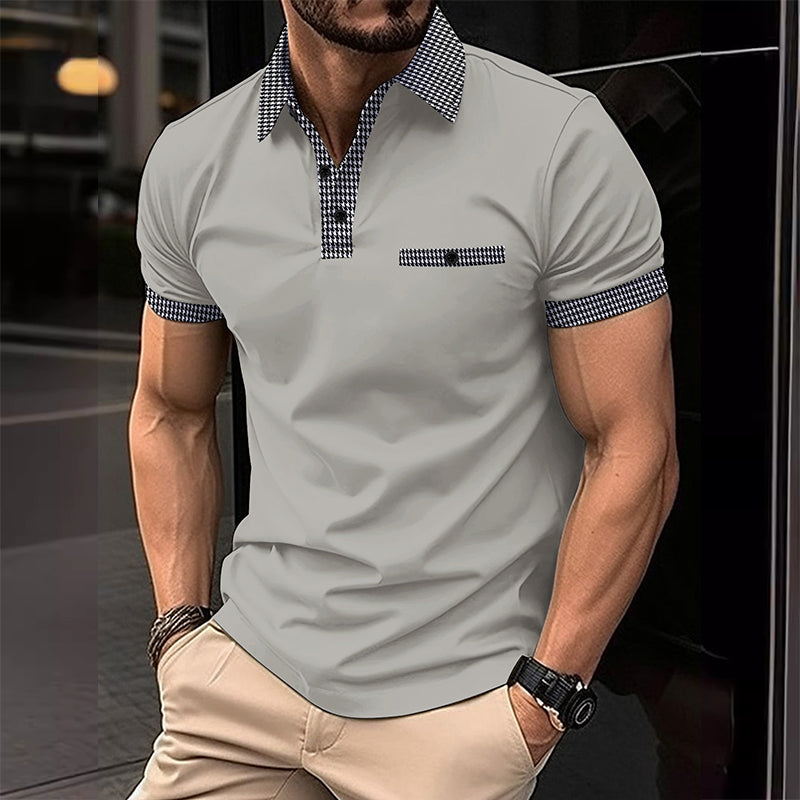 Gray men's polo shirt with checkered collar and sleeve trim paired with beige casual pants