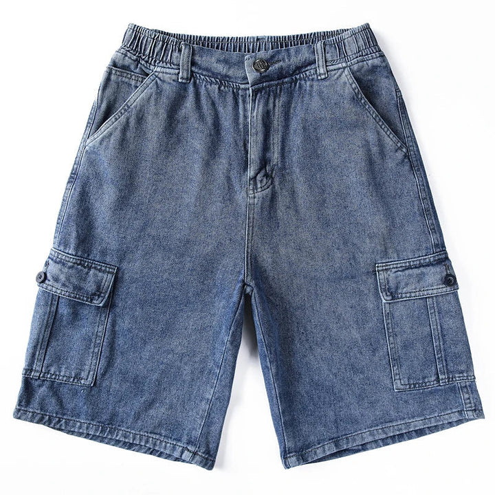 Flat lay of dark gray denim cargo shorts with elastic waist and multiple utility pockets