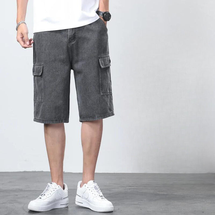 Flat lay of light blue denim cargo knee length shorts with elastic waistband and cargo pockets