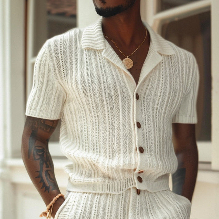 Close-up of cream knit shirt and shorts set with open collar and brown buttons