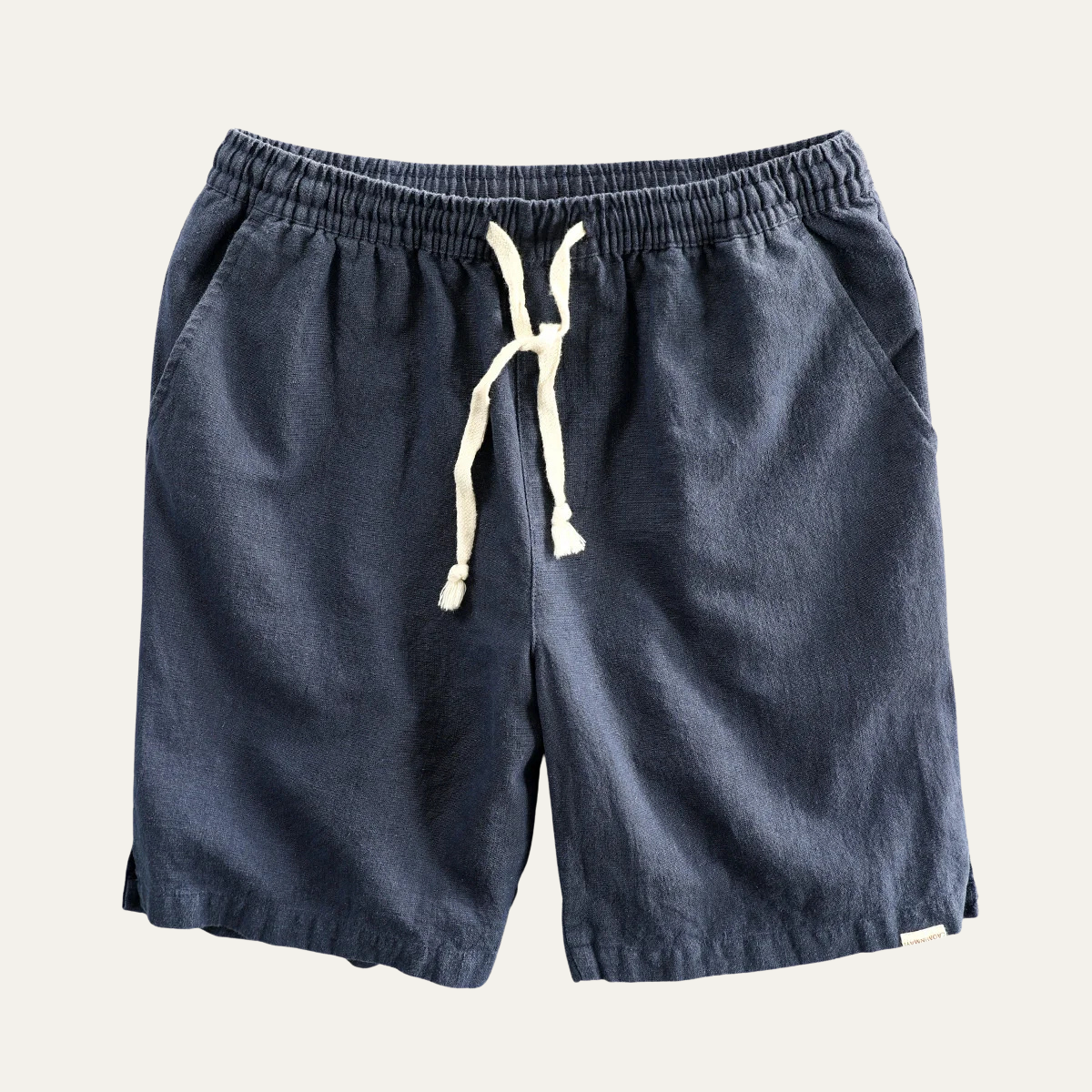 Navy linen beach shorts with drawstring and relaxed straight leg, flat lay