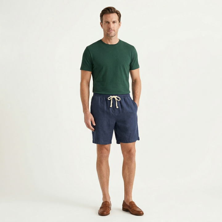 Men linen beach shorts in navy styled with green t shirt and brown loafers
