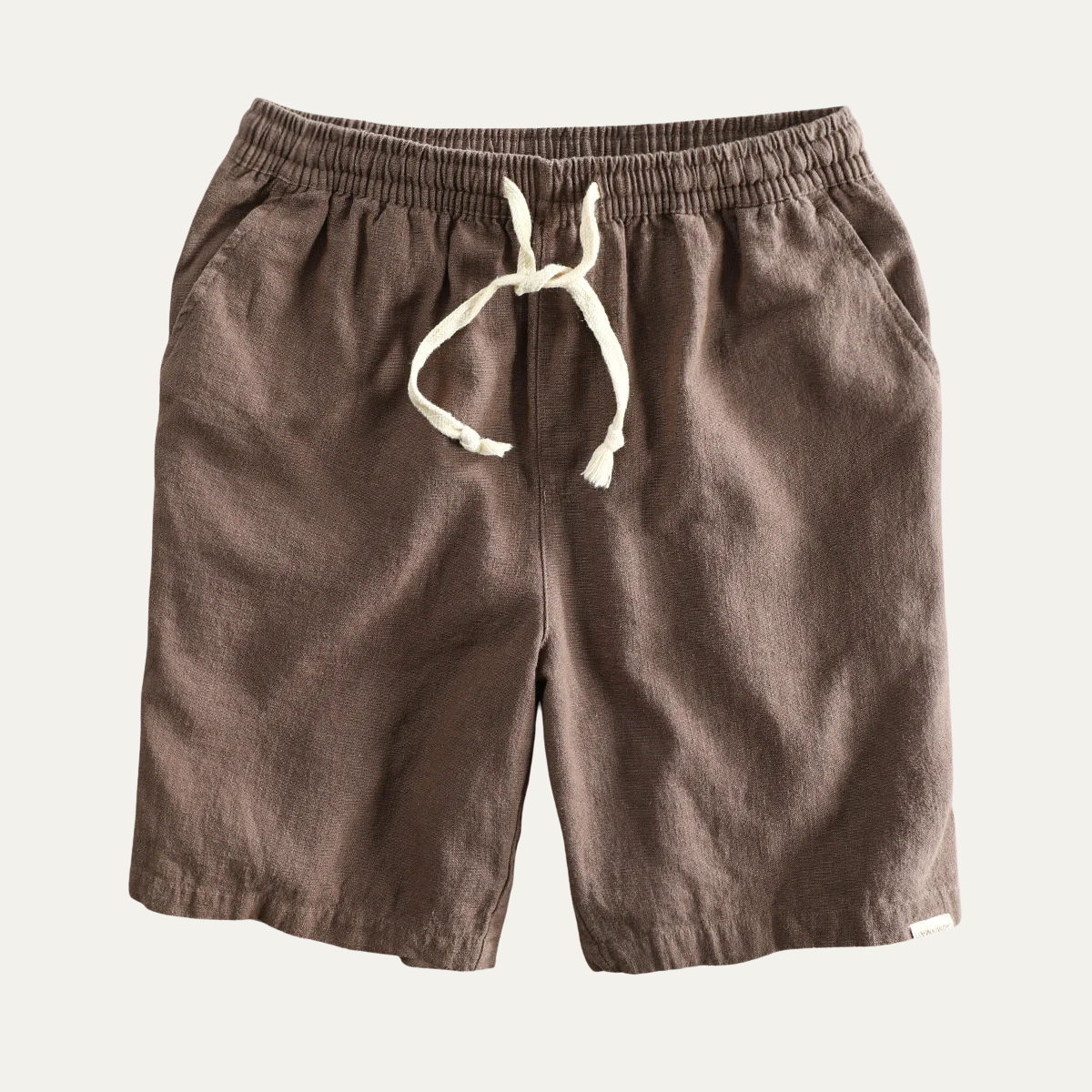 Brown linen beach shorts with drawstring waist, front flat lay product view