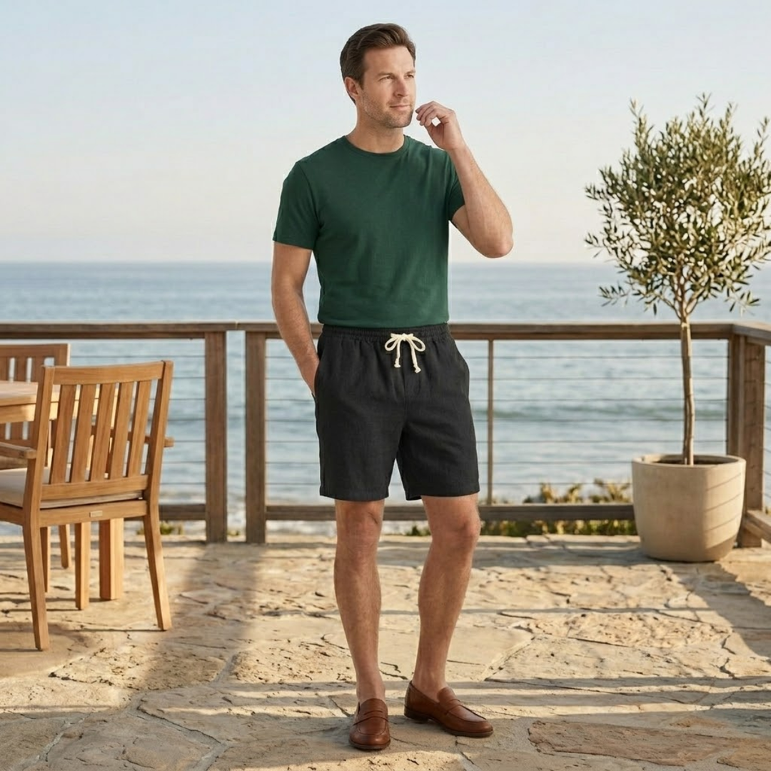 Black linen beach shorts styled outdoors by the sea with drawstring waist