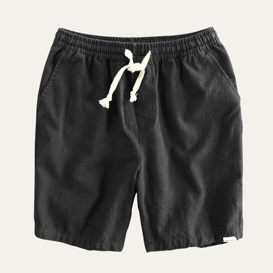 Black linen beach shorts with drawstring waist, front flat lay view
