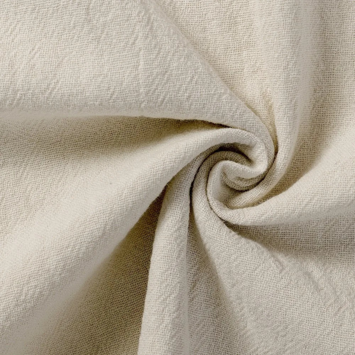 Close-up of beige linen fabric texture on summer shorts material
