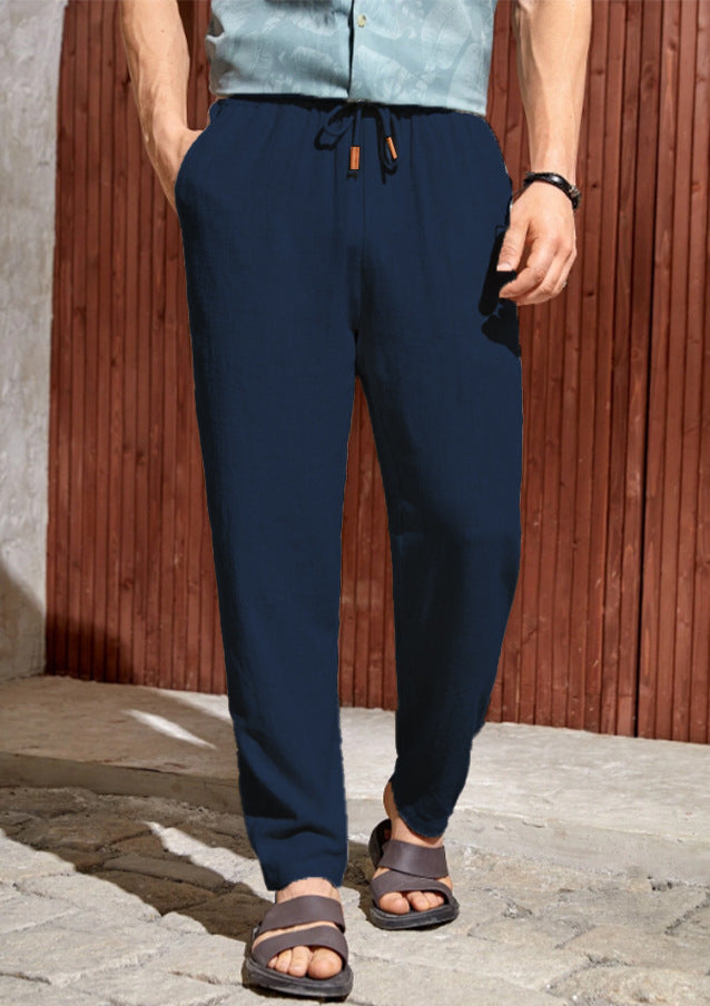 Navy men linen pants featuring a relaxed straight leg and adjustable drawstring waistband