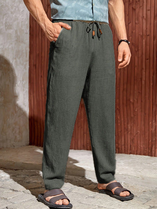 Dark green men's linen pants with straight leg silhouette, drawstring waist, and side pockets