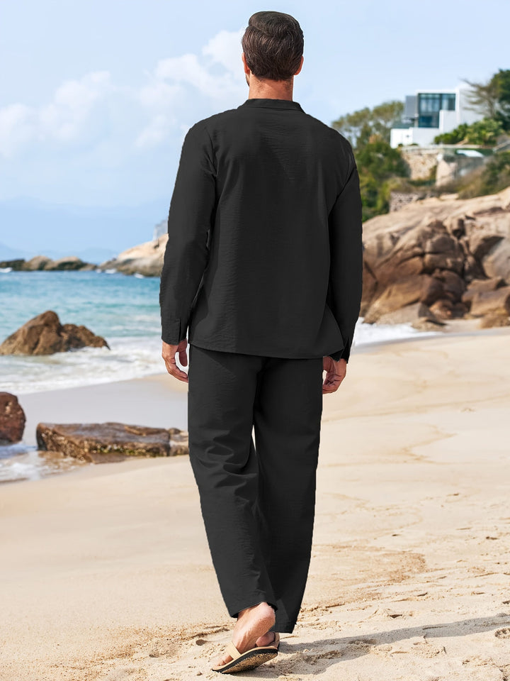 Back view of black long sleeve top and matching pants set, straight leg pants on beach