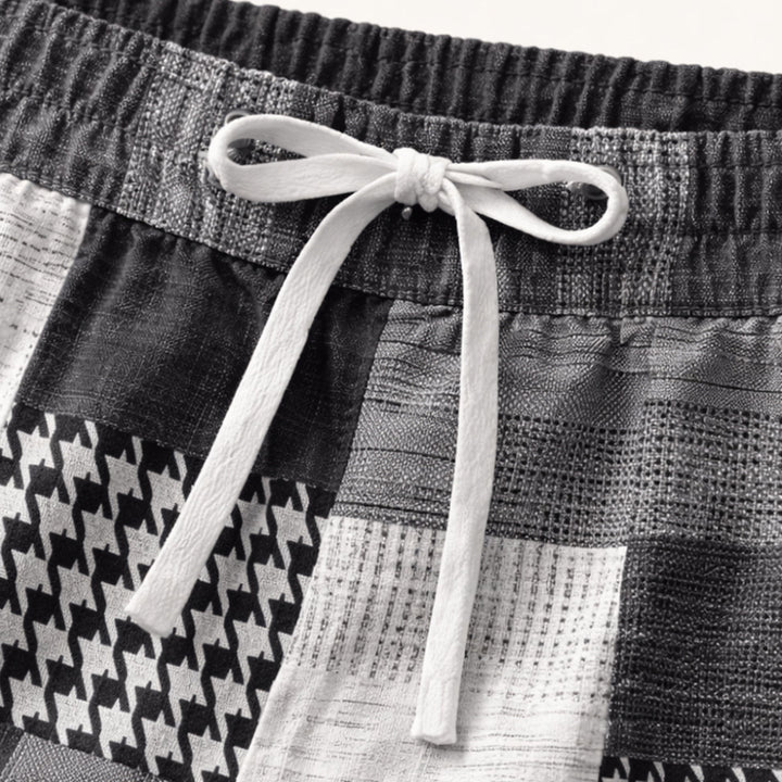 Close-up of patchwork shorts showing elastic waistband, white drawstring, and textured fabric