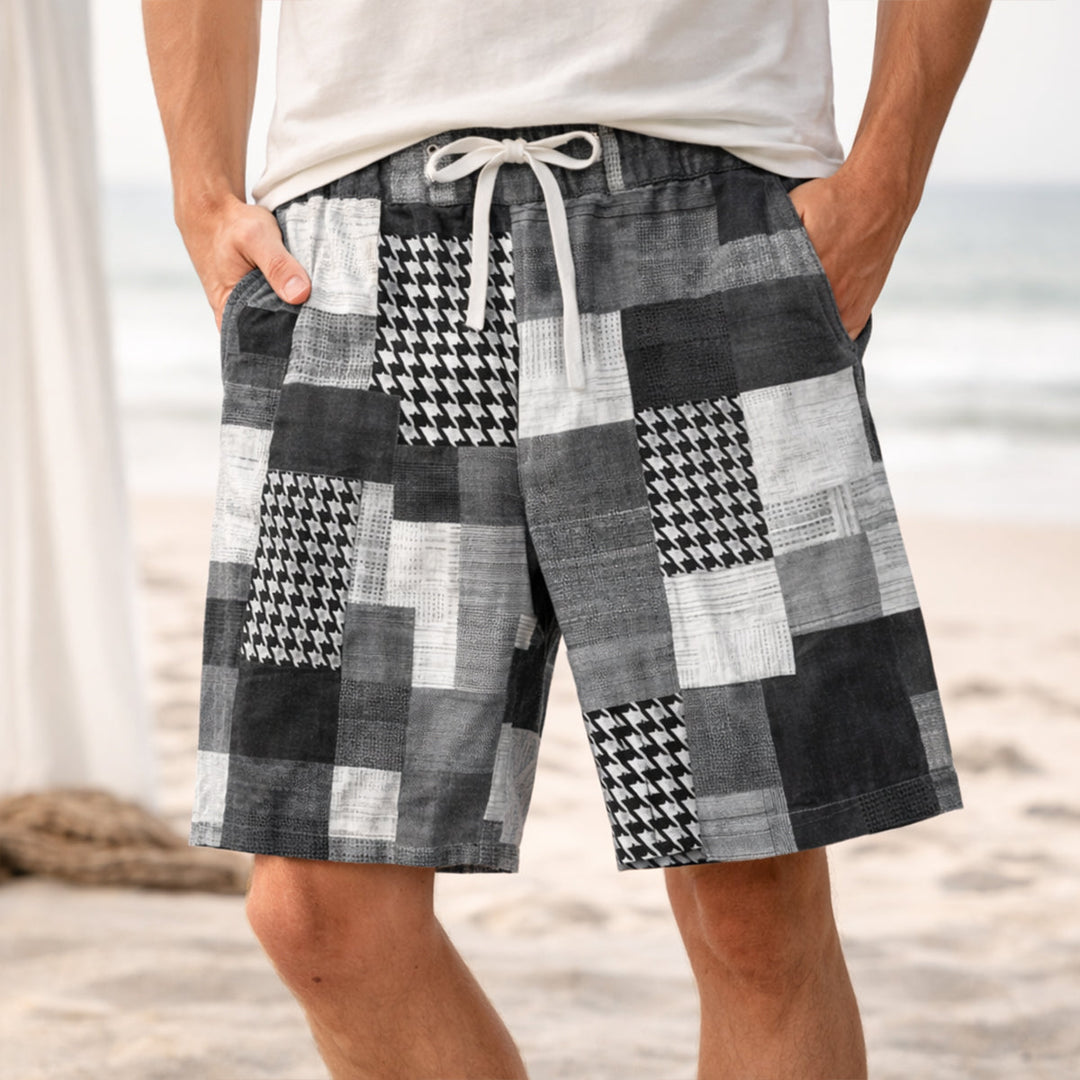 Model wearing black and white patchwork shorts with drawstring waist and side pockets