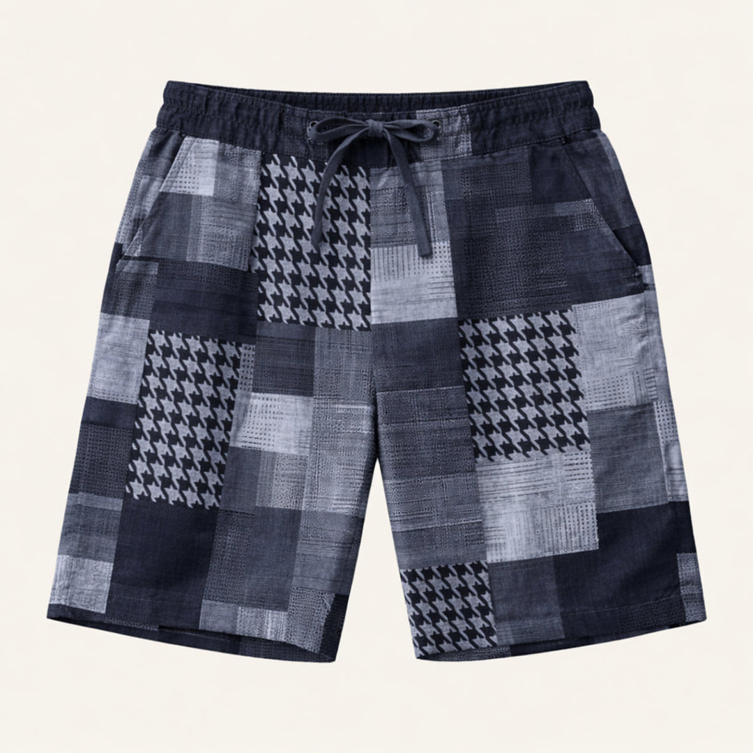 Model wearing green patchwork shorts with elastic waistband and casual beach style