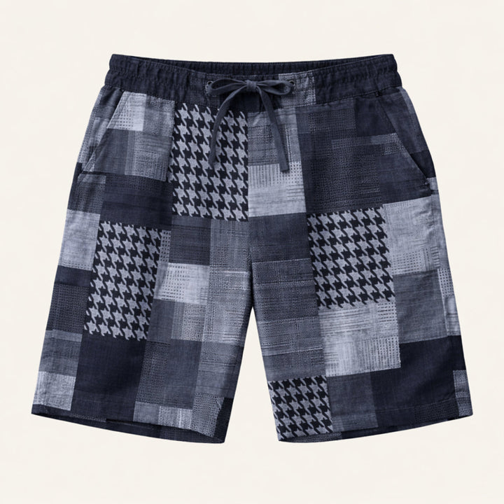 Model wearing green patchwork shorts with elastic waistband and casual beach style