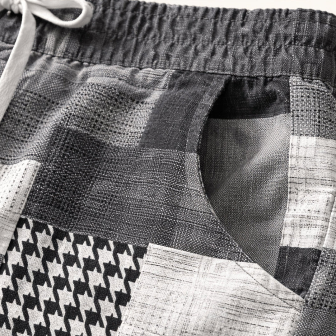 Model wearing navy patchwork shorts with relaxed fit and drawstring waist