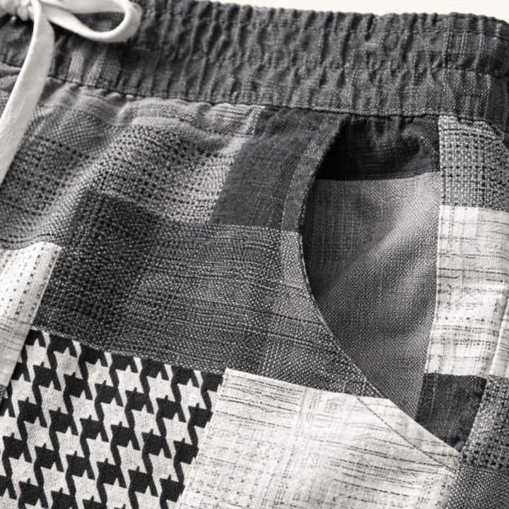 Model wearing navy patchwork shorts with relaxed fit and drawstring waist