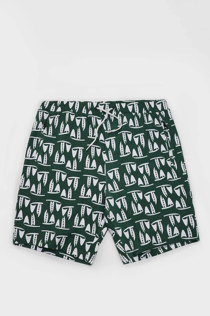Green sailboat print mens drawstring shorts with zipper pockets, flat lay on white