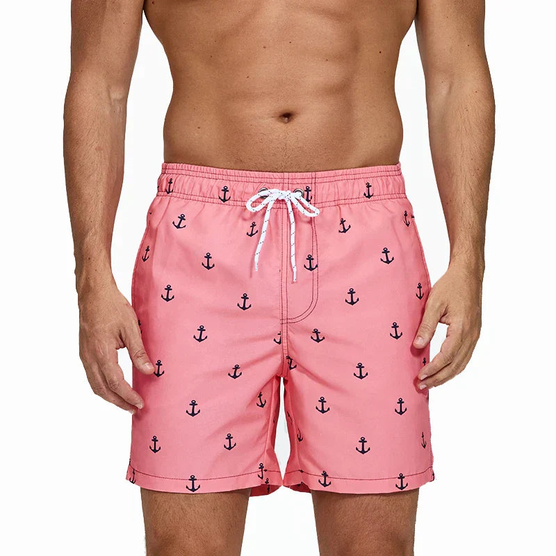 Pink anchor print men swim shorts with pockets and white drawstring waist, front view