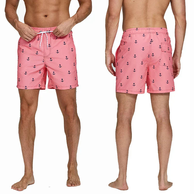 Pink anchor print swim shorts front and back view with pockets and white drawstring waist