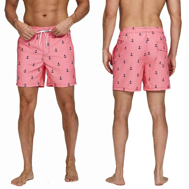 Pink anchor print swim shorts front and back view with pockets and white drawstring waist