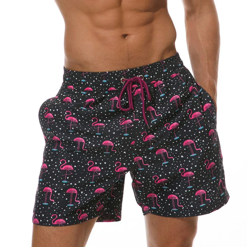 Black flamingo print swim shorts with side pockets and burgundy drawstring waist detail
