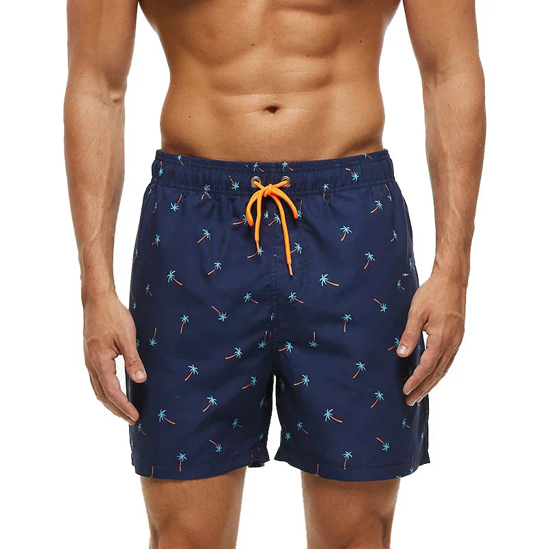 Navy palm tree print swim shorts with orange drawstring waist and side pockets