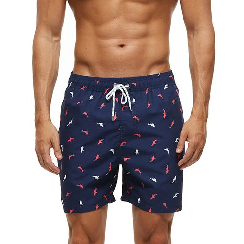 Navy printed swim shorts with shark pattern, side pockets and white drawstring waist