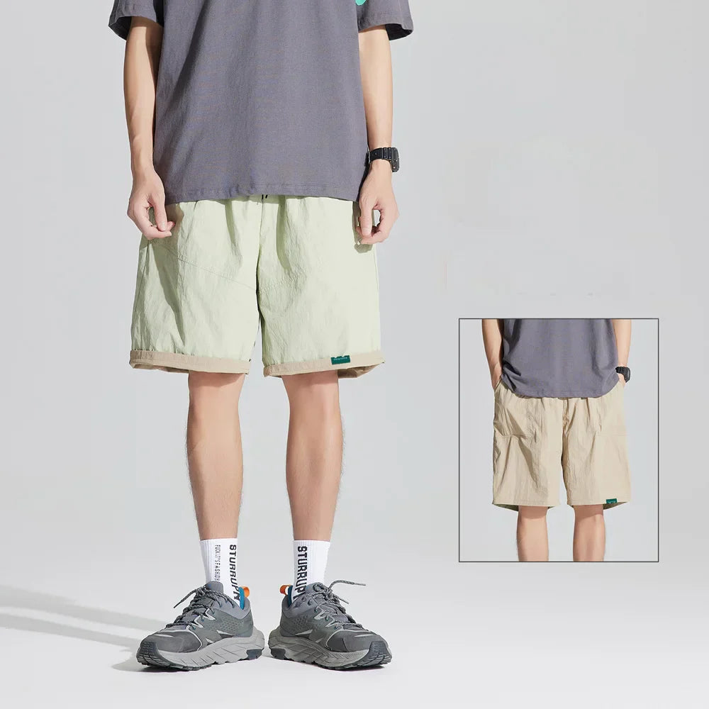 Light green reversible quick dry casual shorts with beige cuffed hem, shown with inset back view