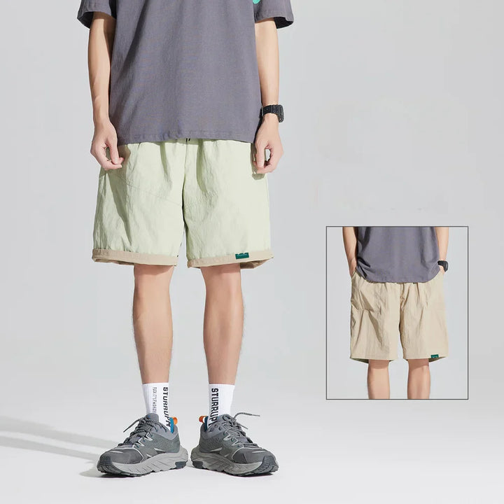 Light green reversible quick dry casual shorts with beige cuffed hem, shown with inset back view