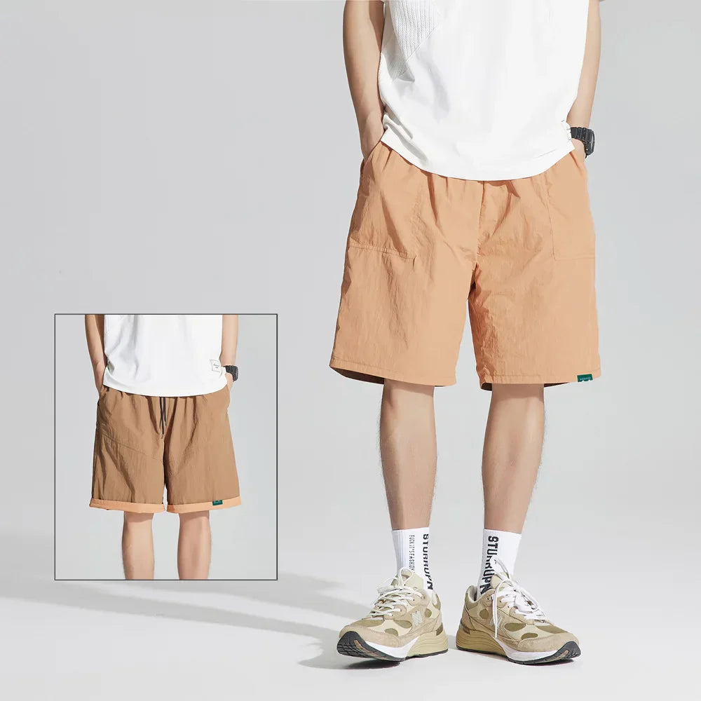 Peach reversible quick dry casual shorts with drawstring waist and side pockets, front view