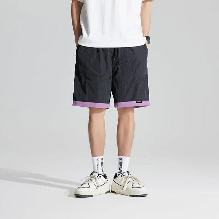 Back view of black reversible quick dry casual shorts with purple hem and relaxed fit