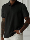 Black short sleeve textured knit polo shirt shown front view with button placket and ribbed cuffs