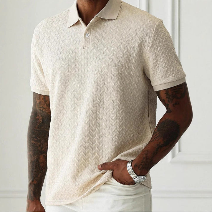 Beige short sleeve textured knit polo shirt with collar and subtle chevron pattern