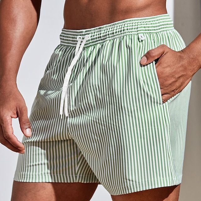 Green and white striped men swim shorts with hand in pocket, elastic drawstring, quick dry swimsuit