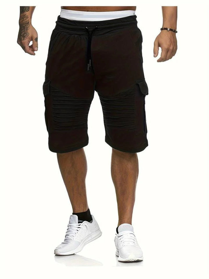 Front view of black men summer cargo knee length shorts with side pockets and ribbed panels