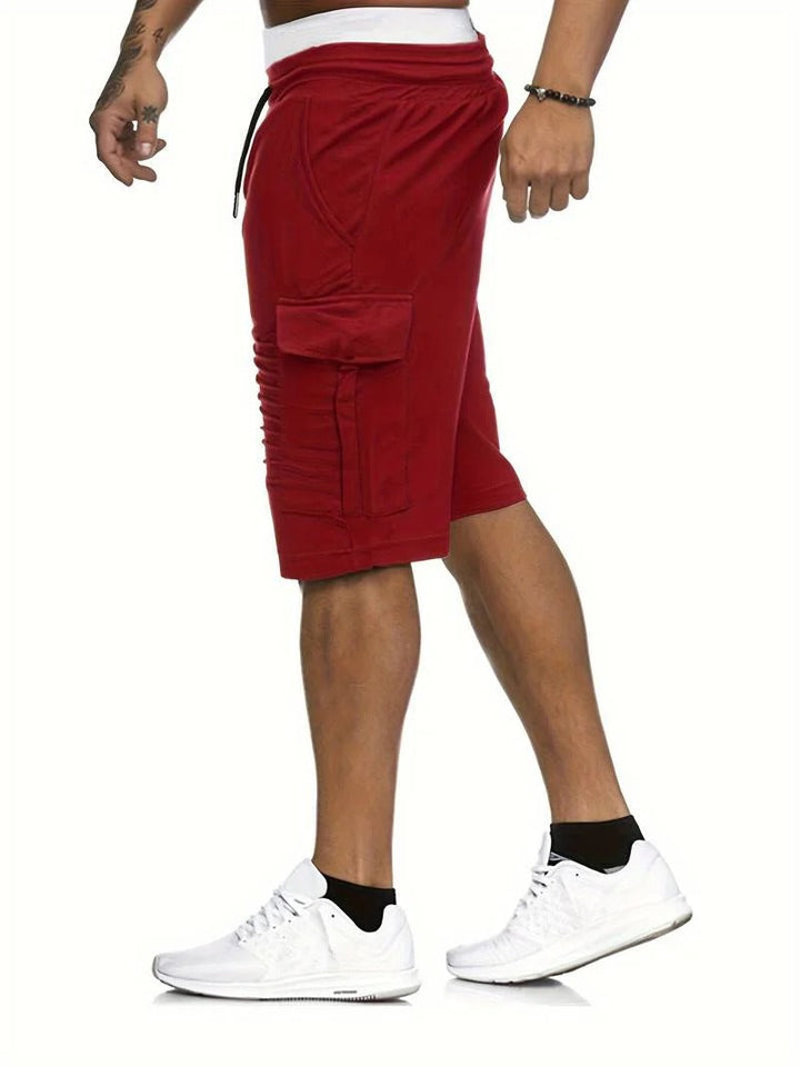 Side view of red men cargo knee length shorts with flap pocket and relaxed summer fit