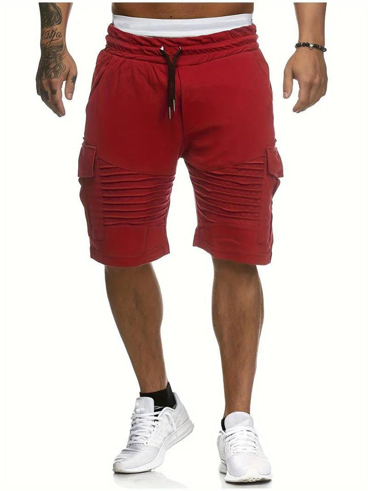 Front view of red men summer cargo knee length shorts with pockets and drawstring waist