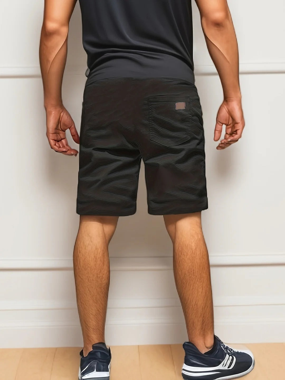 Back view of black cargo shorts for men with elastic waist and relaxed summer fit