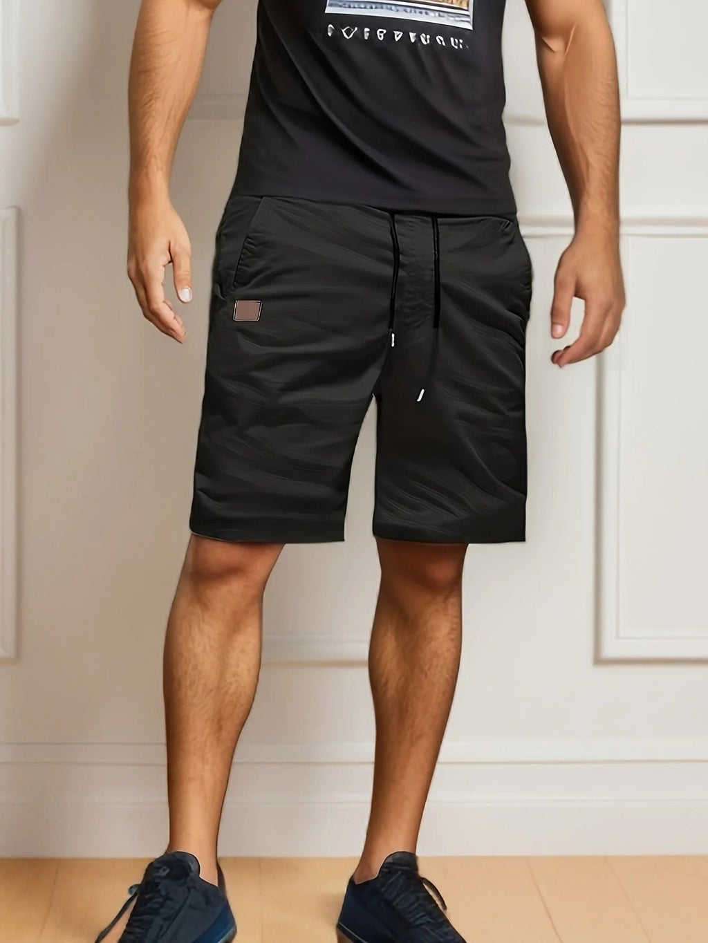 Black men's cargo shorts with elastic waist, drawstring, side pocket, and knee-length fit