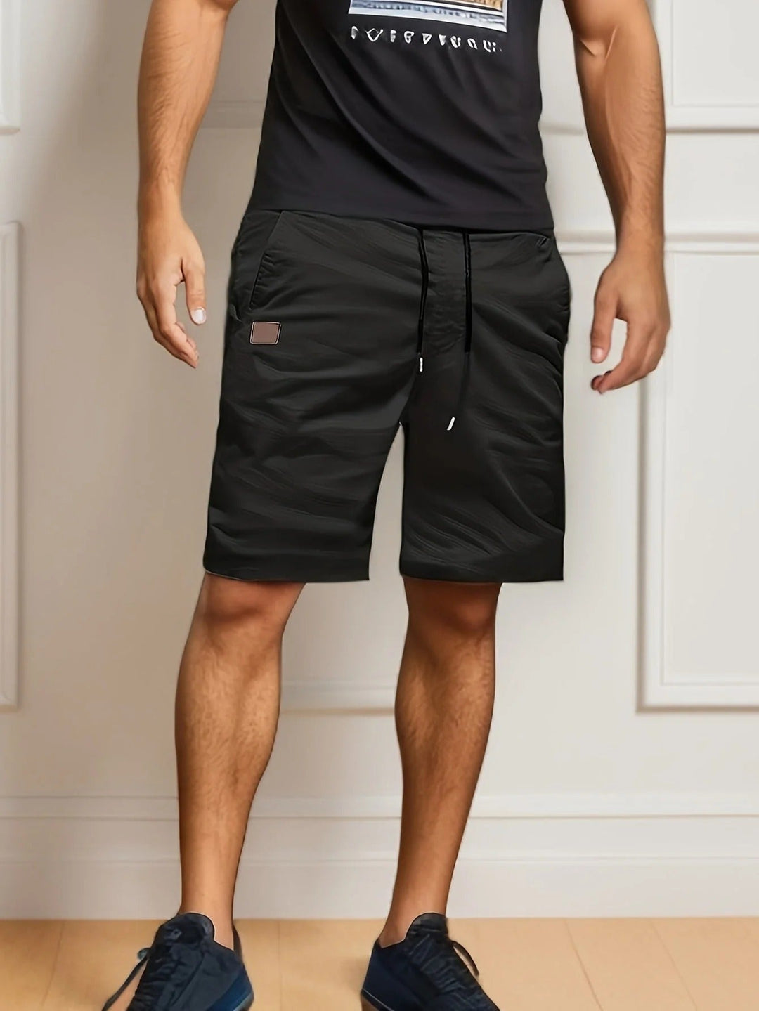 Black men's cargo shorts with elastic waist, drawstring, side pocket, and knee-length fit