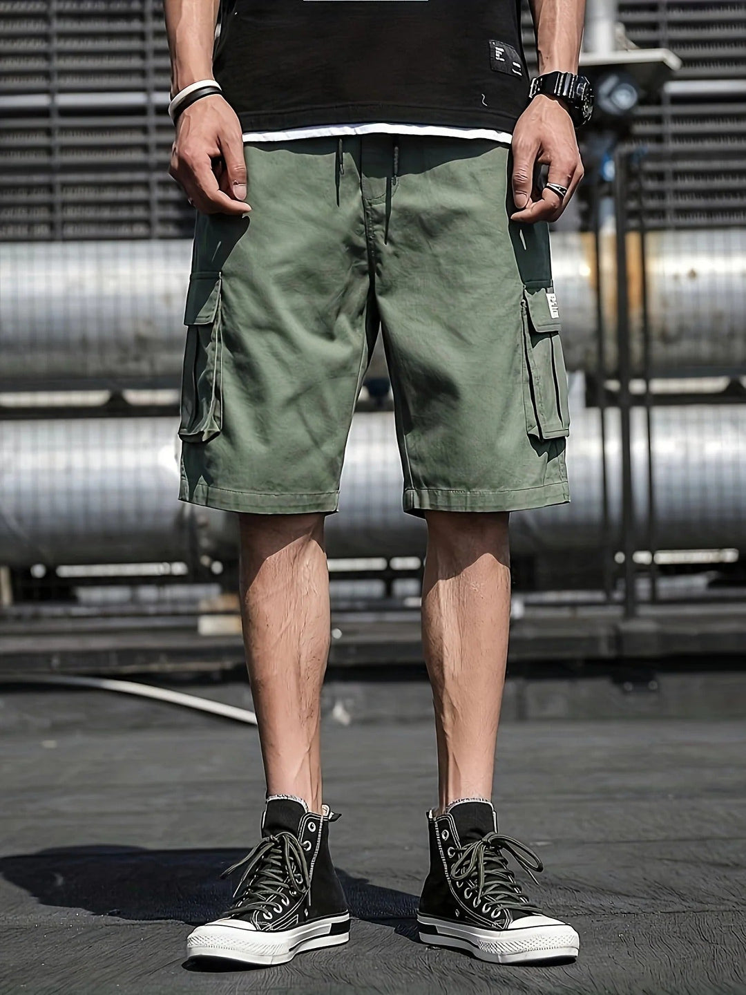 Olive green men summer cargo shorts with flap pockets and relaxed fit, worn with black high-top sneakers