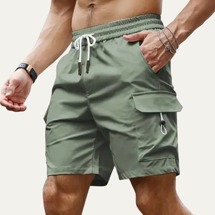 Olive green men summer cargo shorts with pockets, elastic waist, and side flap pocket detail